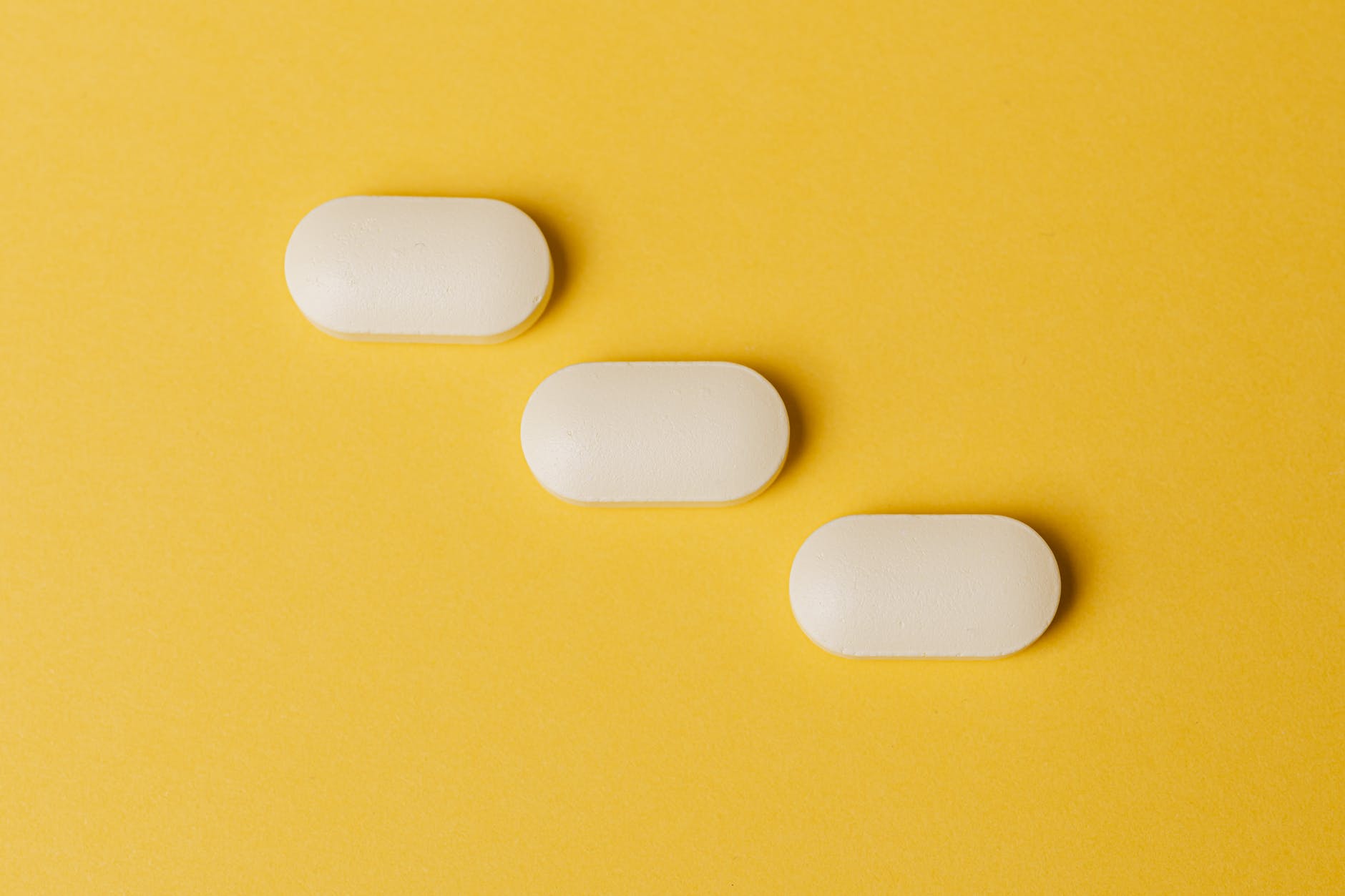 set of pills on yellow surface